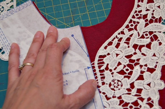 Placing the lace below the V-notch at the neckline on the Oliver + S Hide-and-Seek Tunic