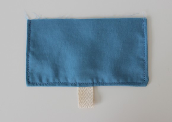 Pocket flap with twill tape loop