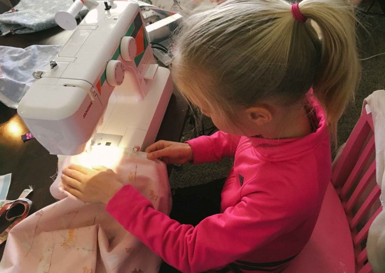 Girl sewing an Oliver + S Lazy Days Skirt