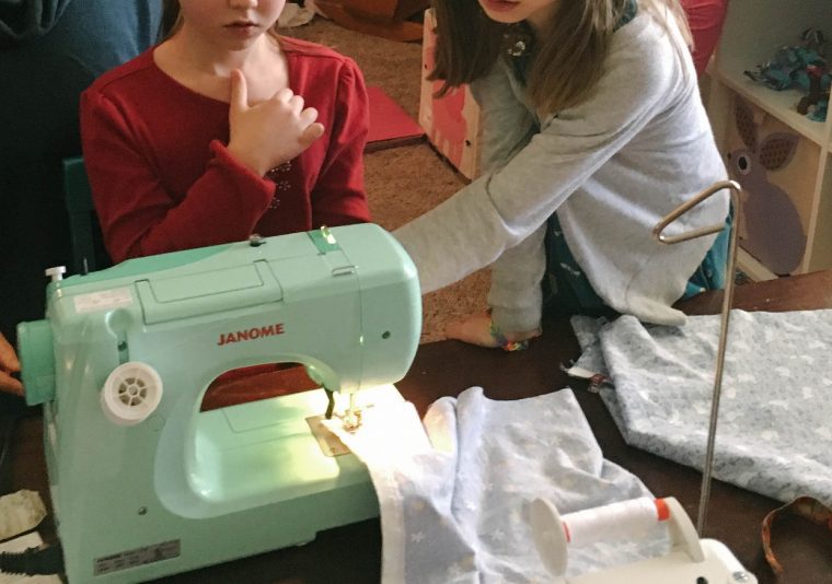 Girl sewing an Oliver + S Lazy Days Skirt
