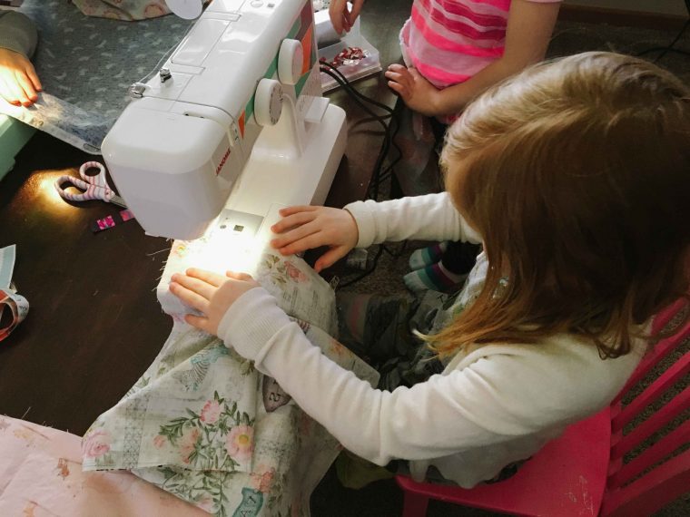 Girl sewing an Oliver + S Lazy Days Skirt