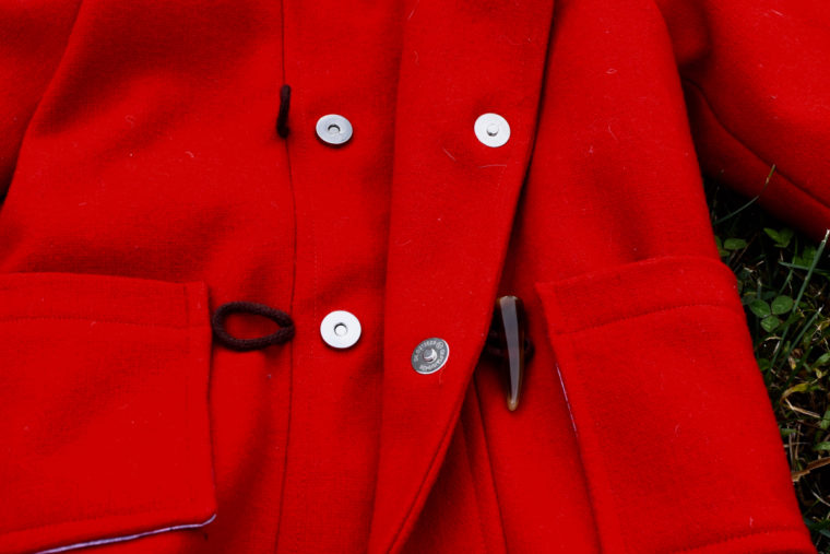 Red wool coat with magnetic snaps.