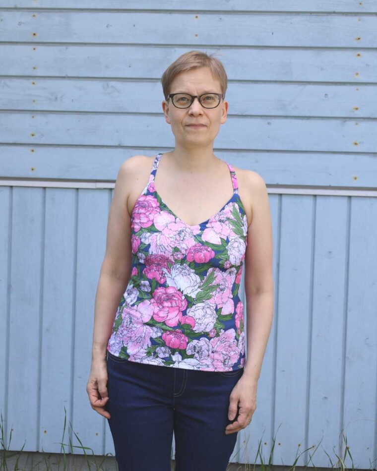 Woman standing in front of a barn wearing Liesl + Co Tribeca Knit Cami swimwear version