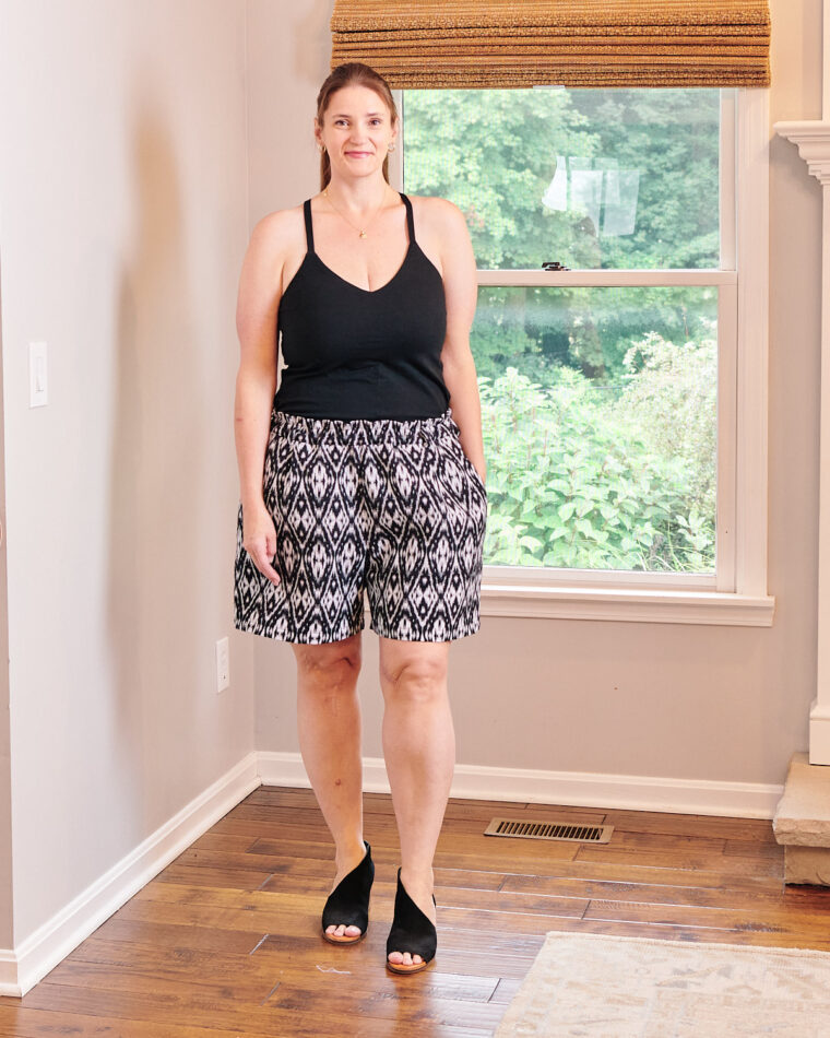 Woman standing in corner of room wearing a Tribeca Cami and Lisboa Shorts