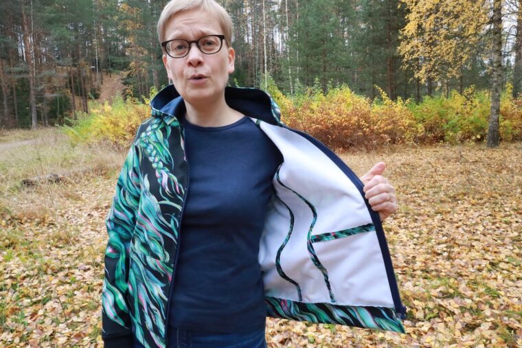 Woman excited to show off the beautiful finishing on the inside of her handmade jacket!