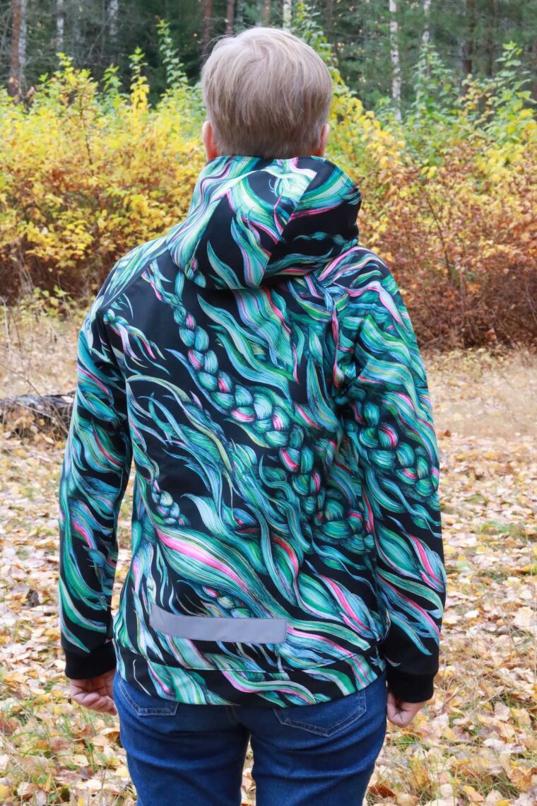 Back view of woman wearing a jacket in a colorful print and reflective tape and that bottom.