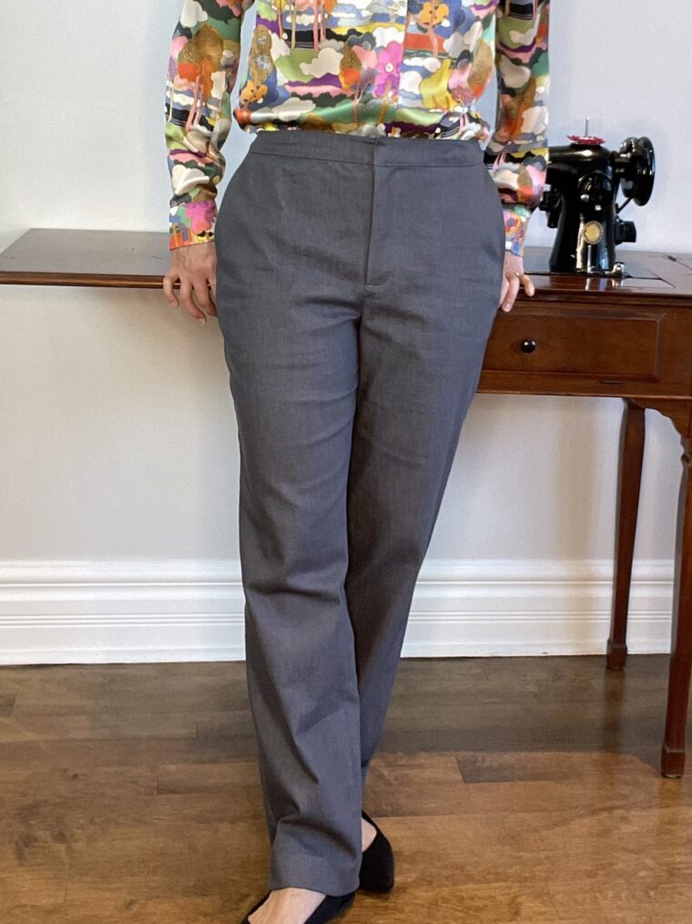 Lower front view of a woman wearing grey trousers