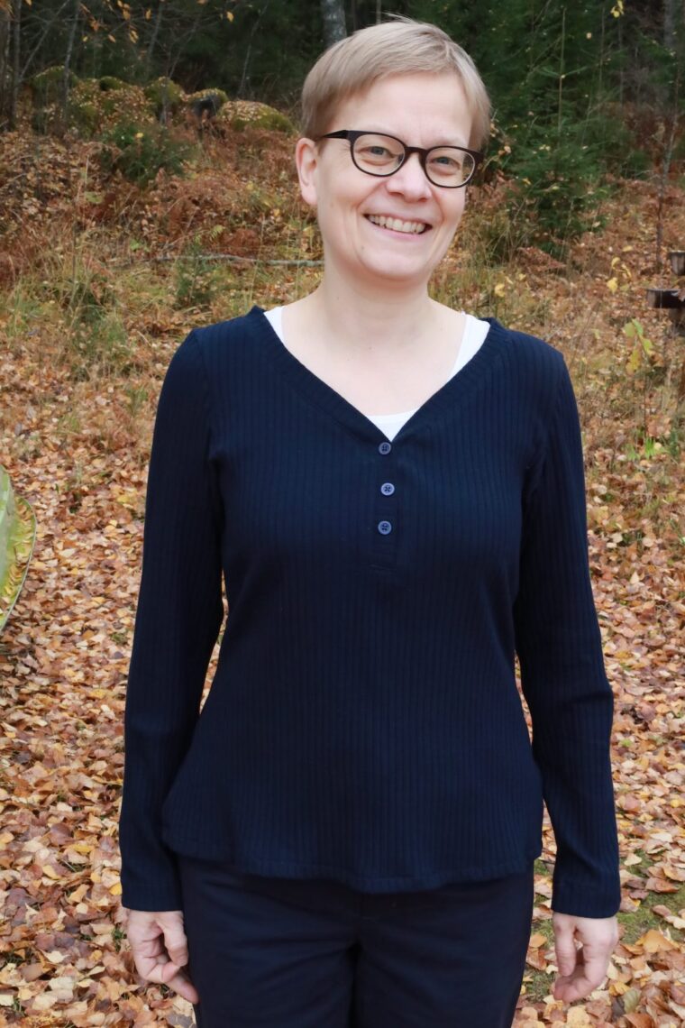 Woman wearing henley knit shirt in a rib fabric