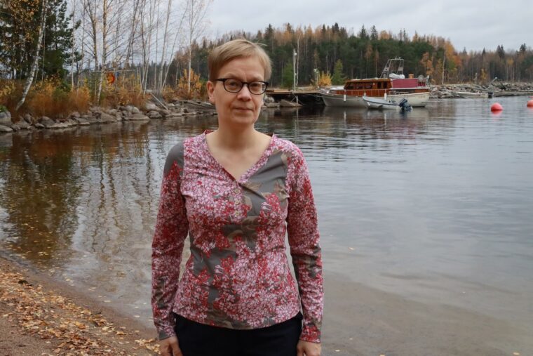 Woman wearing henley knit shirt in a print jersey fabric in size small