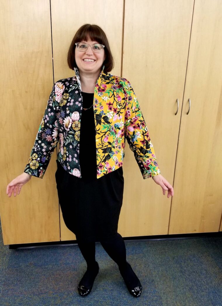 Woman wearing a scrappy jacket and black skirt