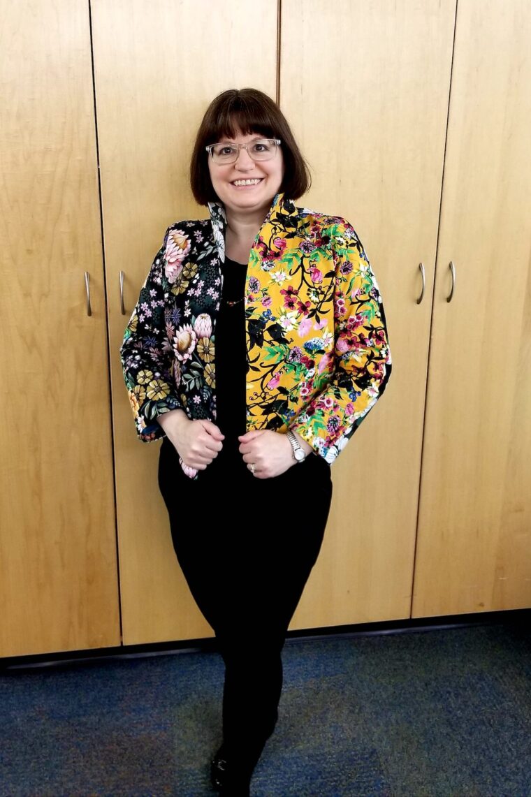 Woman wearing a scrappy jacket and black skirt