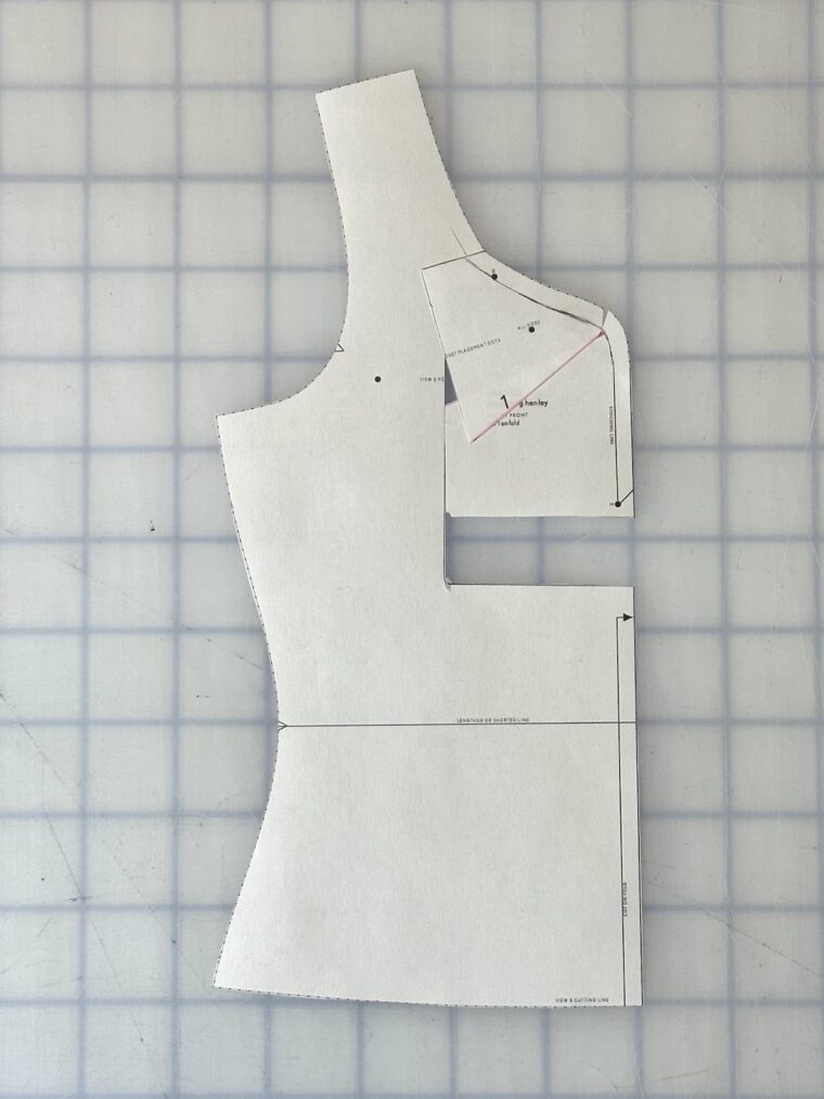 A front bodice pattern piece. I rectangle as been drawn around the center front neckline. The rectangle has been shifted up. The top of the rectangle has been angled to blend with the original neckline.