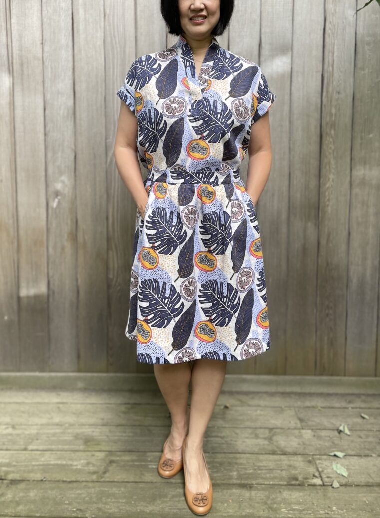 Close up of a woman standing in a backyard wearing a Santa Rosa top and matching Everyday skirt